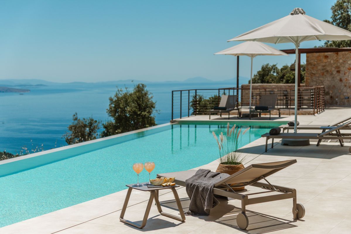 Poolside sun loungers with Ionian Sea backdrop at Villa Mulberry